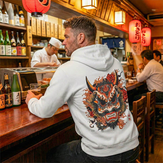 A high-quality flat-lay photo of the Oni Mask Hoodie on a concrete background.